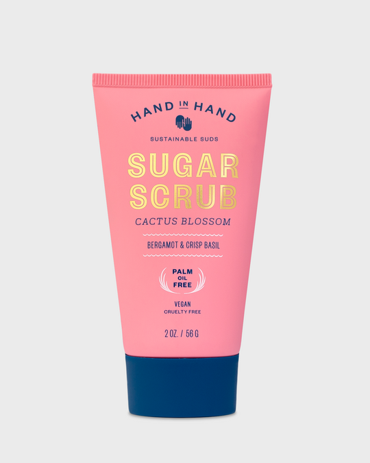 Pink tube of sugar scrub labeled "Cactus Blossom," with notes of bergamot and basil.