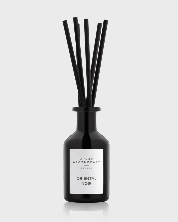 Black reed diffuser with slender sticks, labeled "Urban Apothecary Oriental Noir."